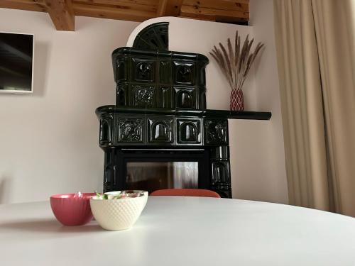 a white table with a black fireplace in a room at Apartmánik pri Zubačke in Tatranska Strba