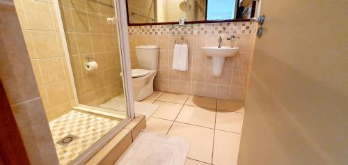 a bathroom with a shower and a toilet and a sink at La Mer 8 - 6 Sleeper - Overlooking Margate Beach! in Margate