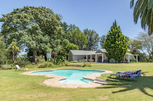 a house with a swimming pool in the yard at Hopefield BnB in Addo