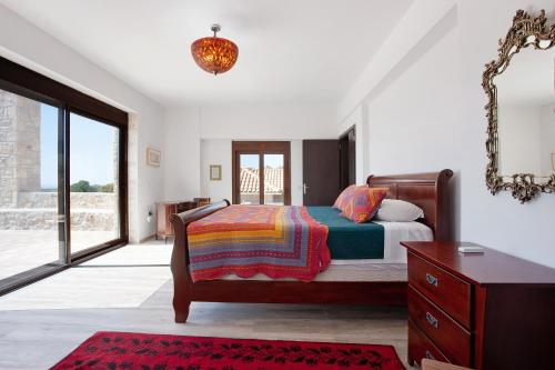 a bedroom with a bed and a dresser and a mirror at Wild Fig Retreat Thalassa and Loft in Maryiés