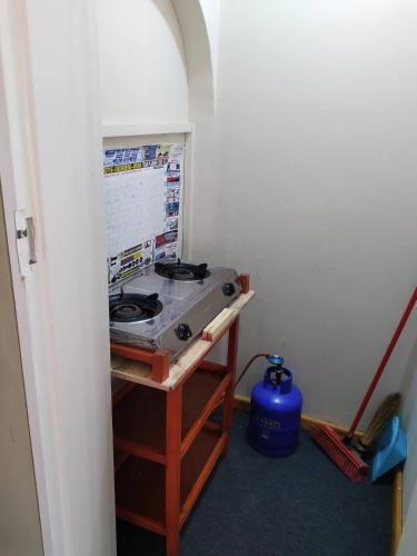 a small room with a stove on a stand at Neat guest suite with office corner - 2101 in Harare