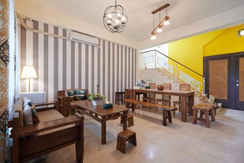 a living room with wooden furniture and yellow walls at Avenue B&B in Hualien City