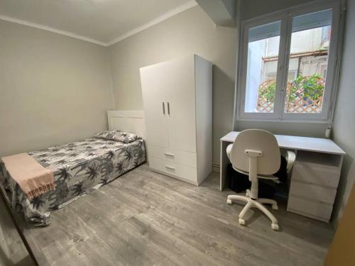 - une chambre avec un bureau, un lit et une chaise dans l'établissement Apartamento acogedor en Logroño, à Logroño