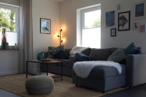 a living room with a couch and a table at Ferienhaus Meerbude in Südbrookmerland