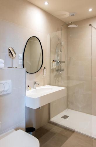 a bathroom with a sink and a shower at Soko Hotels-Pont du Gard in Remoulins
