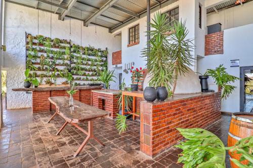 a room with plants on the wall and a table at Villa Paradiso in Hartbeespoort