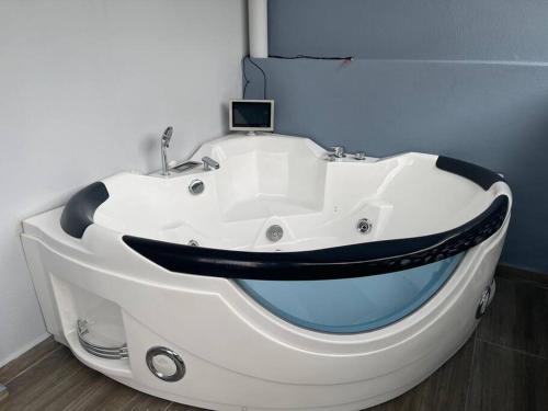 a large white bath tub in a room at *NEW 12Px w KTV/KidsPool/Billiard/Jacuzzi near USM in Gelugor