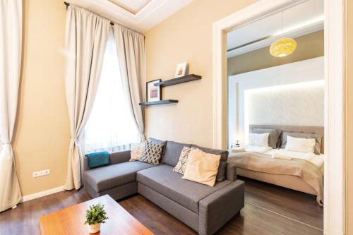 a living room with a couch and a bed at Spacious Luxury apartment at the heart of Budapest in Budapest