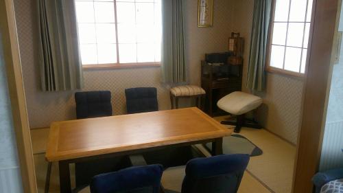 a room with a table and chairs and a window at ホテルていね in Sapporo
