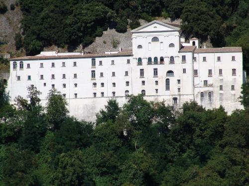 a large white building on the side of a mountain at Villa Marika in Dragonetti
