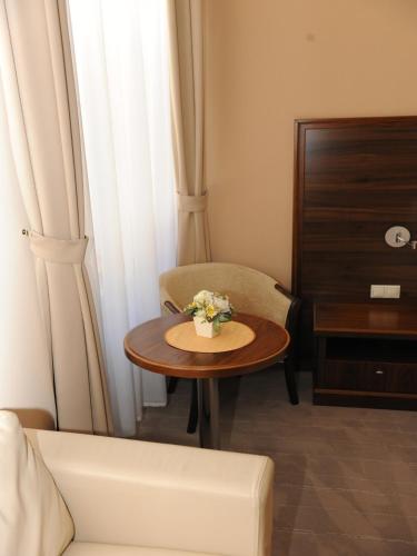 a living room with a table and a chair and a couch at Penzion Kiska Kežmarok in Kežmarok