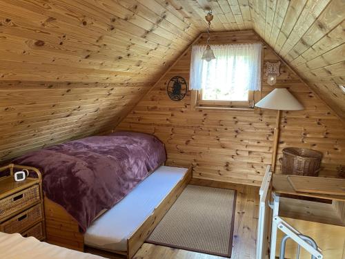 a bedroom in a log cabin with a bed at Ferienhaus mit direktem Wasserzugang in Berlin-Köpenick in Berlin