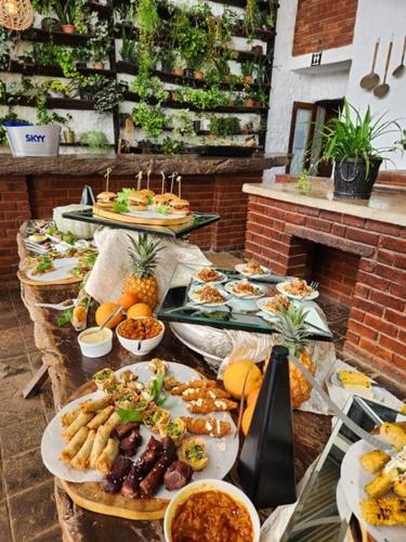 a table with many plates of food on it at Villa Paradiso in Hartbeespoort
