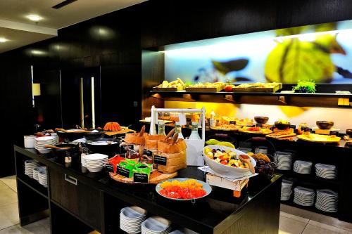 a buffet line in a restaurant with food on it at Quality Hotel Ostrava City in Ostrava