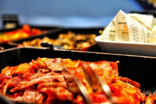 a bunch of food in pans on a table at Quality Hotel Ostrava City in Ostrava
