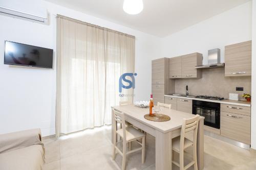 a kitchen with a table and chairs in a room at Al Posto Giusto - Self Check in in Cefalù