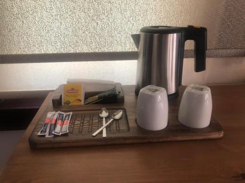 a tray with a coffee maker and a coffee pot and spoons at Ziyagil Konağı in Amasya