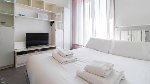a bedroom with a white bed with towels on it at Italianway - Voghera 11 B in Milan
