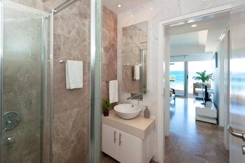 a bathroom with a sink and a shower at Apartment Marina - Beachfront in Protaras