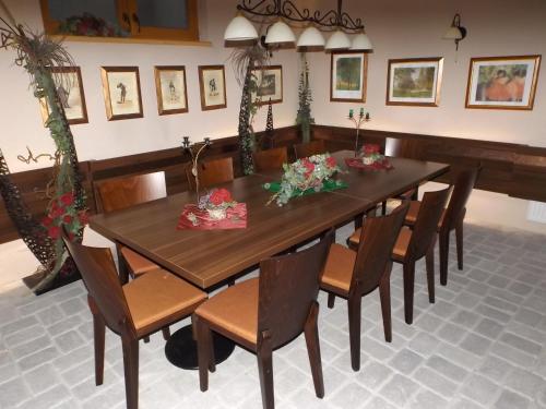 a dining room with a wooden table and chairs at Penzion Kiska Kežmarok in Kežmarok
