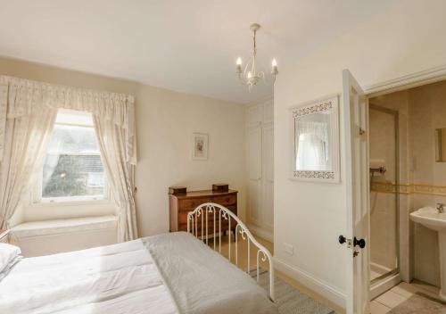 a bedroom with a bed and a sink and a window at Kingston House in West Witton