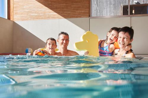 a group of people in a swimming pool at Reka-Feriendorf Urnäsch in Urnäsch
