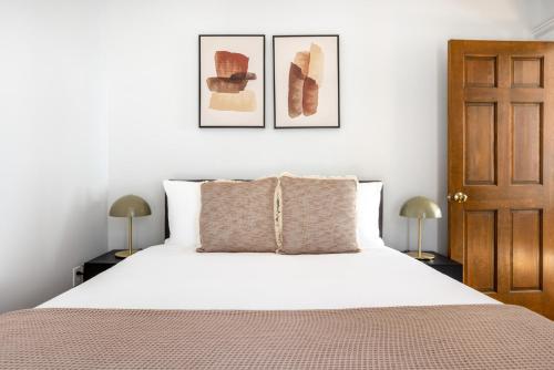 a bedroom with a white bed with two lamps at Beacon Hill 2br w wd nr Boston Common BOS-826 in Boston
