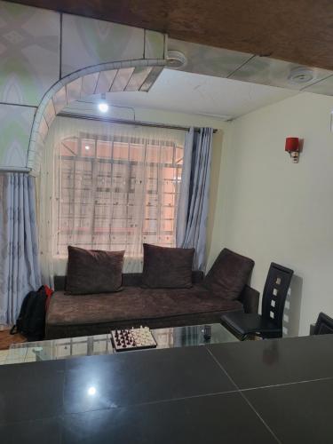 a living room with a couch and a glass table at G&G Homes Ngala Nakuru in Nakuru