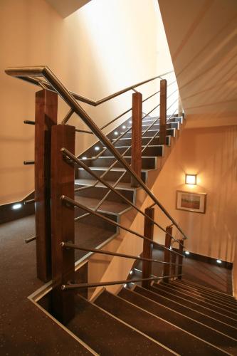 a staircase in a building with a metal railing at Penzion Kiska Kežmarok in Kežmarok
