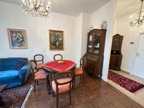 een woonkamer met een tafel en een blauwe bank bij Ghita house luminoso appartamento a 700 m dal mare in Rimini
