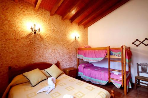 a bedroom with two bunk beds in a room at TODIMER FINCA ALPUJAREÑA in Vélez de Benaudalla
