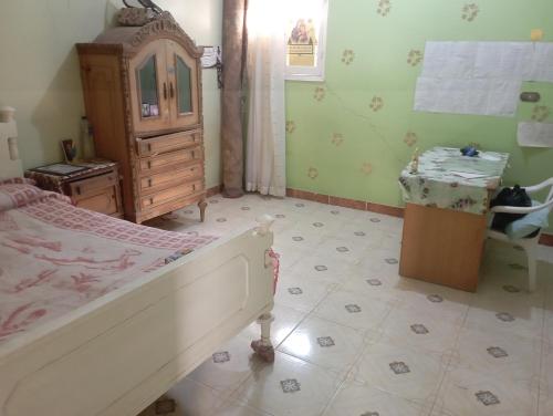a bedroom with a bed and a dresser in a room at Large and cheerful home with 2 floors in Fayoum Center
