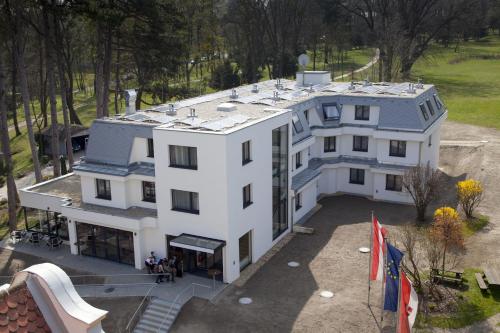 an aerial view of a white building with a roof at Seminarhotel Springer Schlössl in Vienna