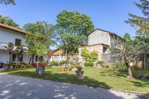 a house with a yard with statues in front of it at Domačija Mirko in Miren