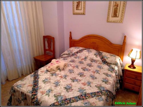 a bedroom with a bed with two shoes on it at Apartamento Solaes Climatizado in Benicarló