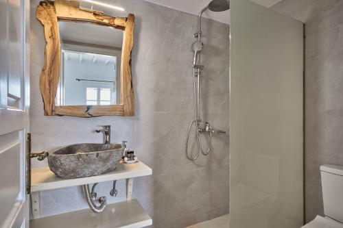 a bathroom with a sink and a mirror at Philippi Villa in Mikonos