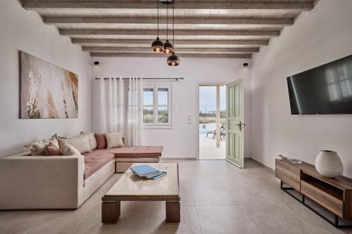 a living room with a couch and a table at Philippi Villa in Mýkonos City