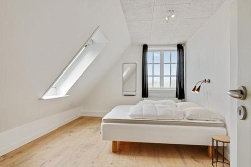 a white room with a bed and a window at Amazing Home In Løkken With 2 Bedrooms in Løkken