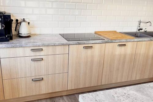 a kitchen with a sink and a counter top at Amazing Riverside home/Kayaks&Sauna/Grill&Garden in Pabradė