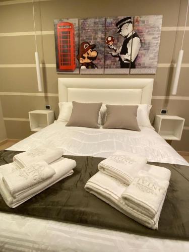 a white bed with three towels on top of it at MR Living Bed & Breakfast in Boiano