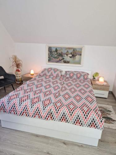 a bedroom with a bed with a red and white quilt at Apartments Karin in Bled
