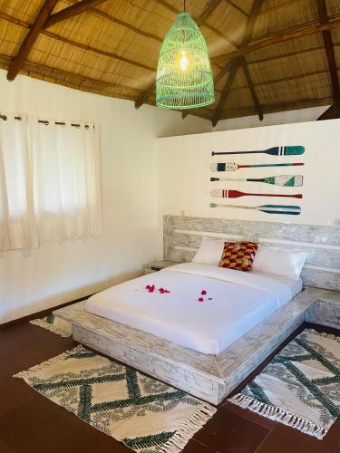 a bedroom with a bed in a room at Mangal Beach Lodge in Vilanculos