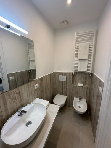 a bathroom with a sink and a toilet and a mirror at MIRA taormina rooms in Taormina
