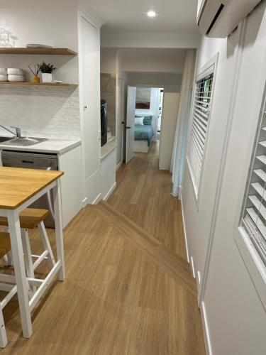 a kitchen and living room with a table and a counter at Hunchy Hideaway in Montville