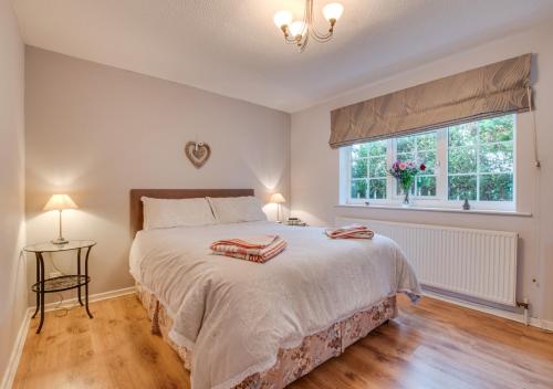 a bedroom with a large bed and a window at Heather House in Whitby