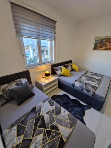 a living room with two beds and a window at Modern Dream Apartment in Neum