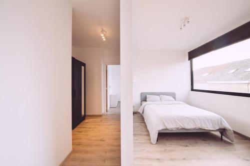 two images of a bedroom with a bed and a window at K&Y suites 1,Brussels airport 500m in Zaventem