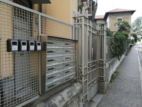 a fence with drawers on the side of a street at Al Molo 2 in Como