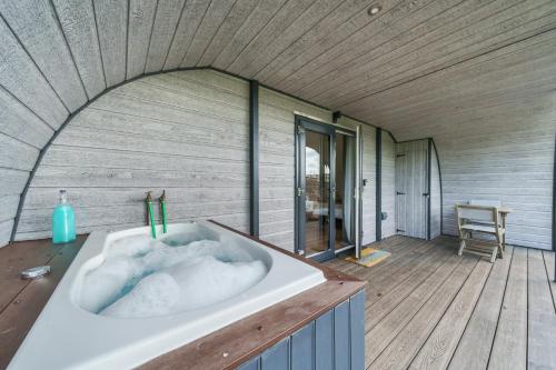 a bathroom with a bath tub in a house at Luna's Lookout in Cilcain