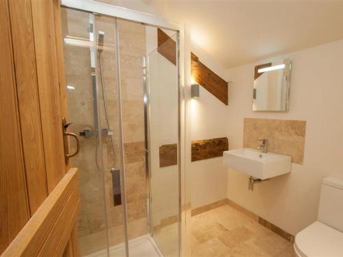 a bathroom with a shower and a sink at Sunny Brow Hayloft in Ambleside